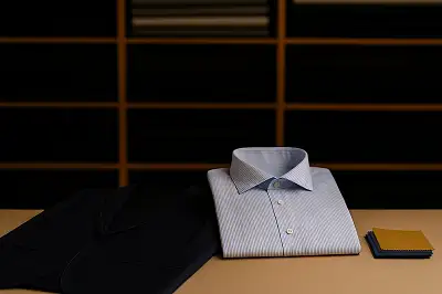 Bespoke tailor in Hong Kong taking measurements for a custom suit